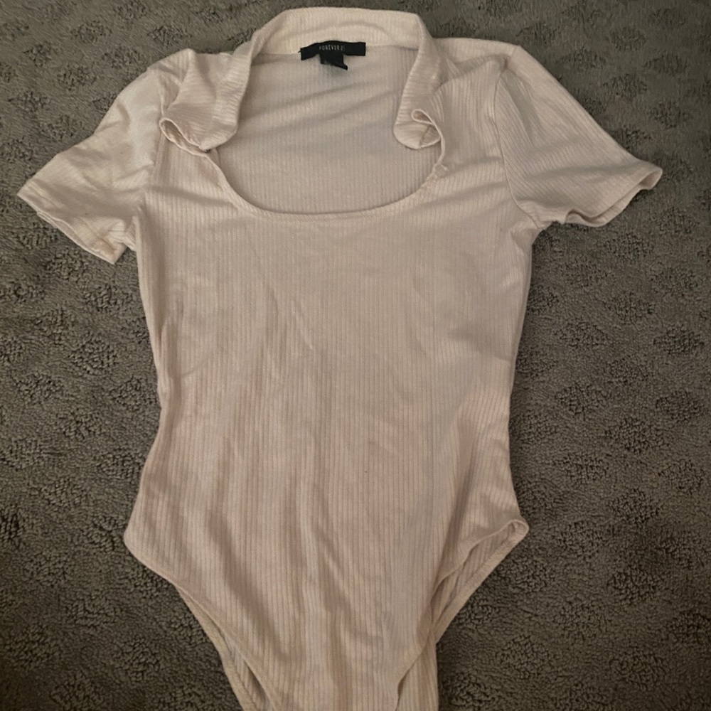 A cream bodysuit